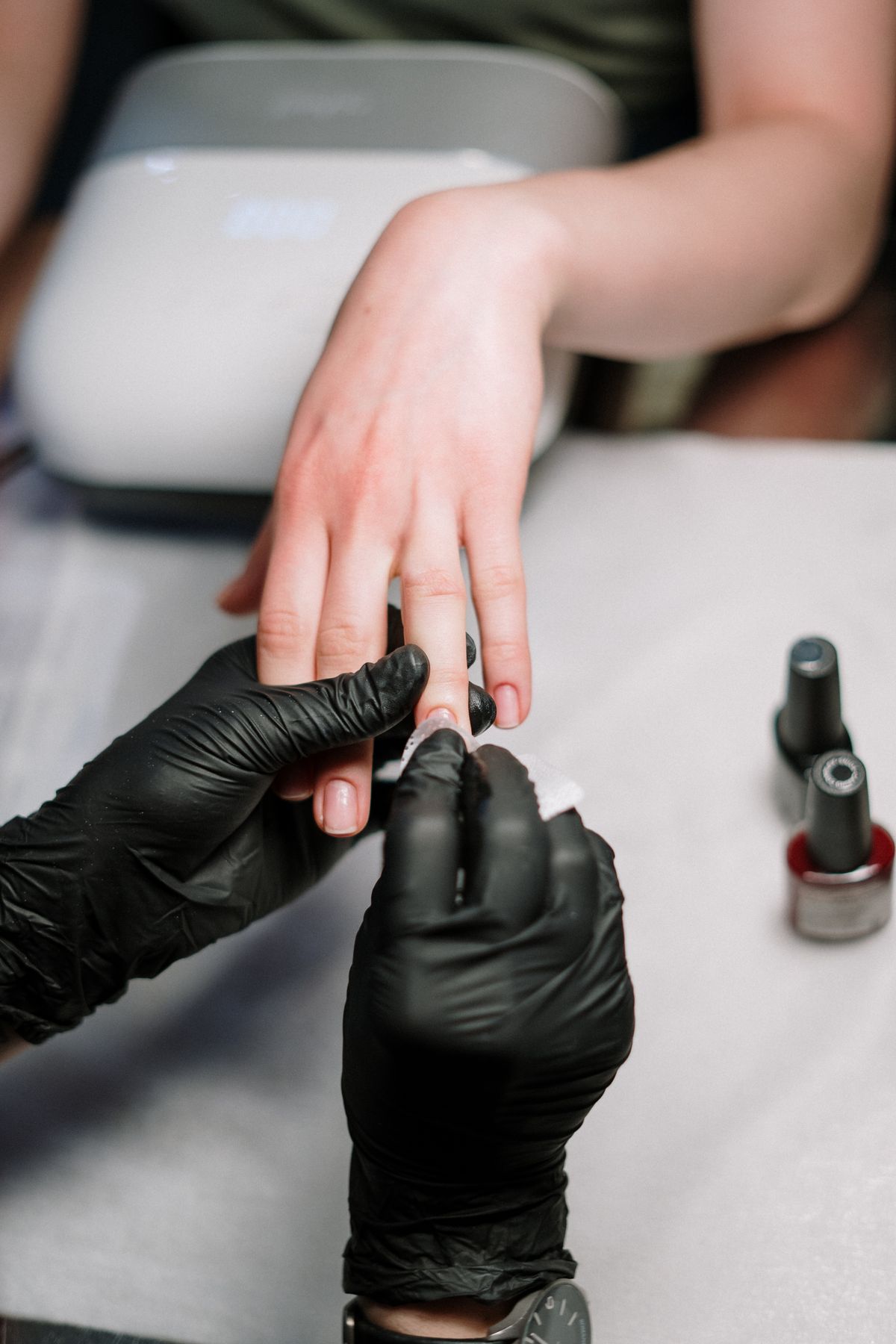 Nail technician applying polish at Miore Nails & Spa